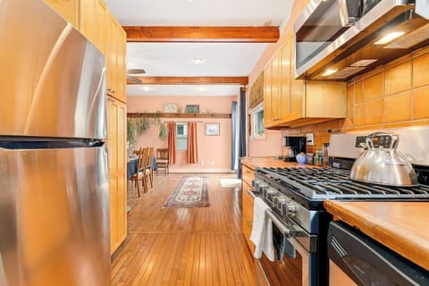 Fully equipped and filled with light, the kitchen opens to the backyard for easy outdoor dining.