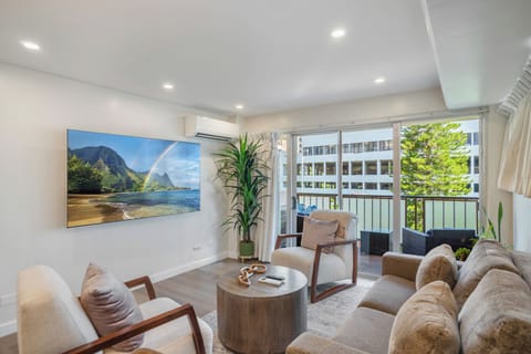 Living Room - Welcome to your Waikiki retreat; an inviting living room with a sofa sleeper, smart TV, and open lanai where indoor comfort meets island breeze.
