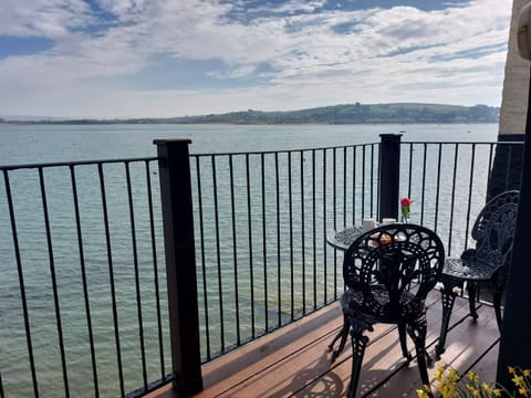 Shoreline Balcony And Seating Area With Coastal View