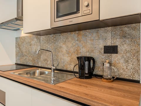 Countertop, Kitchen, Plumbing Fixture, Interior Design, Flooring, Sink, Tap, Cabinetry, Floor, Plumbing