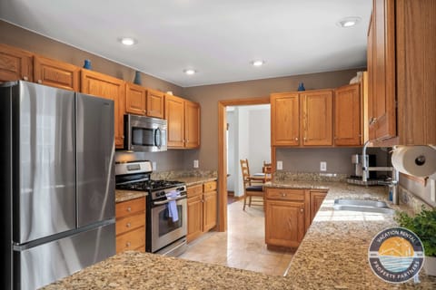 Fully equipped kitchen with stainless appliances and granite counters.