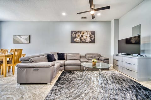 Modern living room with a large leather sectional and a glass coffee table.