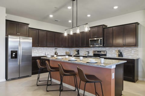 Modern kitchen with granite counters, bar seating, and sleek design!