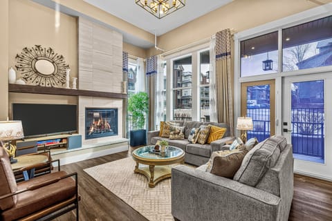 Spacious living room with soaring ceilings and abundant natural light. 