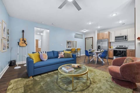 Living Room: Vibrant space with a guitar display, chic decor, and bright dining area for fun gatherings!