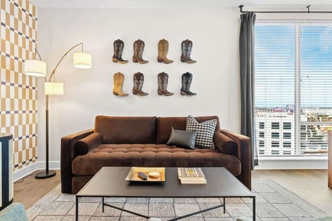 Living Room: Chic space with vintage boots decor and bright Nashville views—perfect for relaxation!