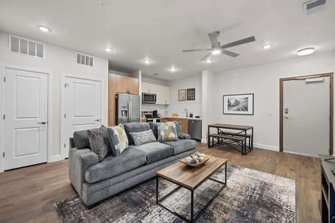 - Bright living room with cozy sofa open layout and warm lighting vibe  
- Modern design perfect for relaxing stays close to top city hotspots  
- Open flow adds comfort style and inviting space for every guest visit
