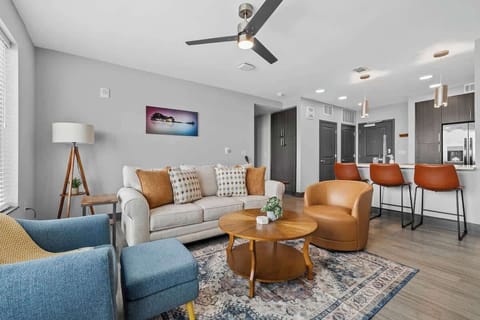 - Bright living room with modern seating and city views  
- Cozy setup with leather chairs and soft accents  
- Perfect lounge space for relaxing and connecting  
