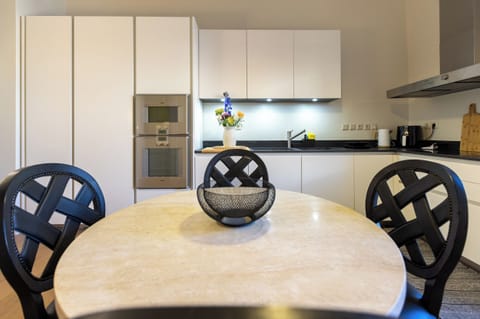 Round dining table seating four guests, in the kitchen