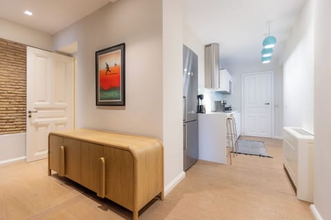 The fully equipped kitchen has all modern appliances, a GAGGENAU stove & microwave, perfect for a self-catered holiday, and a breakfast bar with two stools.