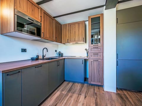 Wood, Interior Design, Flooring, Kitchen, Countertop, Cabinetry, Major Appliance, Floor, Ceiling, Room