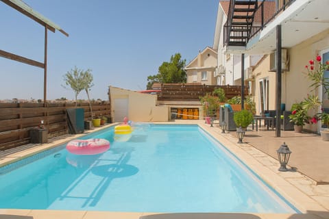 Private pool behind the house, shared with your host and the second guest room