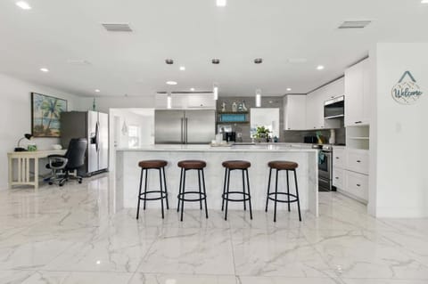 Pull up a seat at the stylish kitchen counter, featuring four comfortable high chairs—perfect for casual meals, morning coffee, or chatting with the cook. 