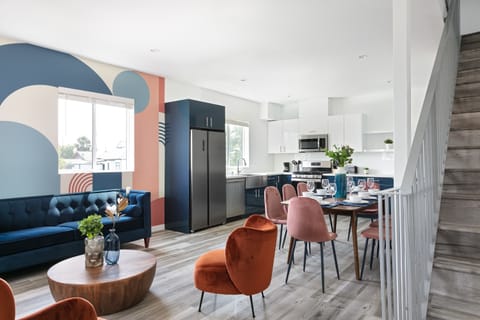 Open living and dining area with bold accent wall and modern decor