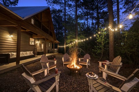 Enjoy a cozy outdoor fire pit with Adirondack chairs, string lights, cornhole.