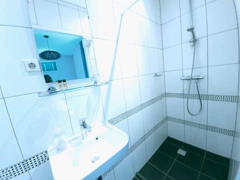 Shower, hair dryer, towels, toilet paper