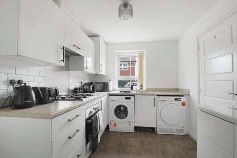 Whip up your favourite meals in this sleek, fully equipped kitchen—complete with modern appliances