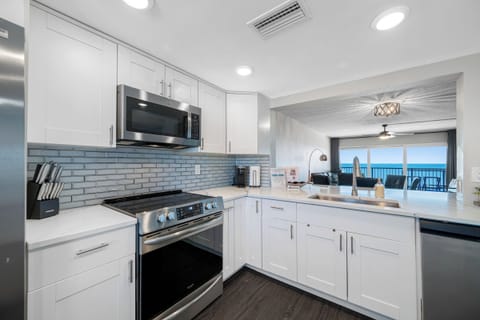 Bright, fully equipped kitchen with stainless steel appliances and sleek cabinetry, perfect for home-cooked meals.