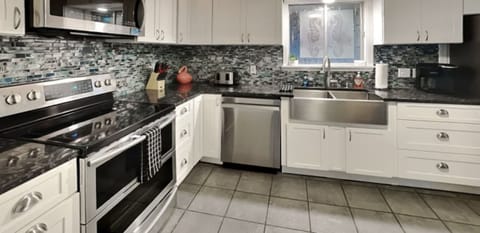 Open concept kitchen- Refrigerator, microwave, dishwasher and stove.