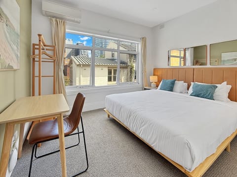 large king bed with pillow topped mattress and sun drenched window
