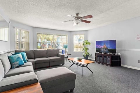 Spacious and bright open-concept living room, featuring a sectional couch.