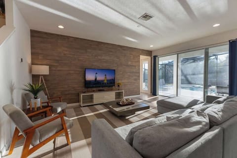 An open concept living room with charming and modern decoration.
