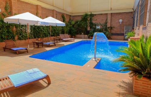 Seasonal outdoor pool, open 10:00 AM to 9:00 PM, pool umbrellas