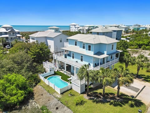 Stunning coastal retreat with private pool, tropical landscaping, and ocean access in a charming beachside neighborhood.