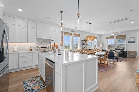 Fully equipped kitchen with large island, stainless steel appliances, and ample counter space for cooking.