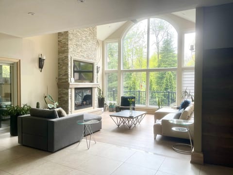 Spacious seating area with floor-to-ceiling windows and natural light