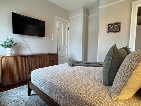 Comfortable and thoughtfully designed bedroom with soft neutral tones.