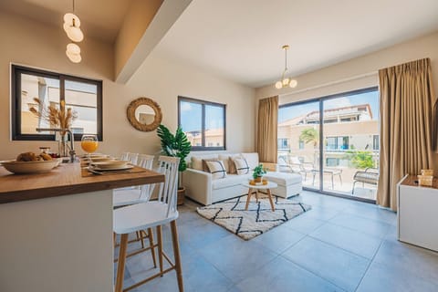 Bright and airy open-concept living area with cozy seating and direct access to the outdoor patio—perfect for relaxing after a day in the sun.