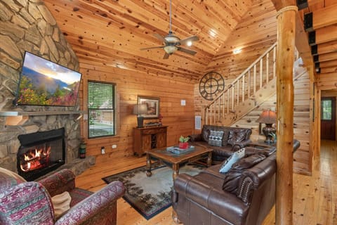 Enjoy a warm welcome the moment you enter—this open-concept space features soaring ceilings, a stone fireplace, and handcrafted wood finishes throughout.
