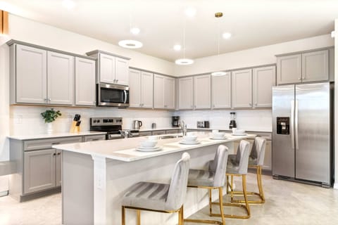 Stunning chef’s kitchen with breakfast bar, stainless steel appliances, and style