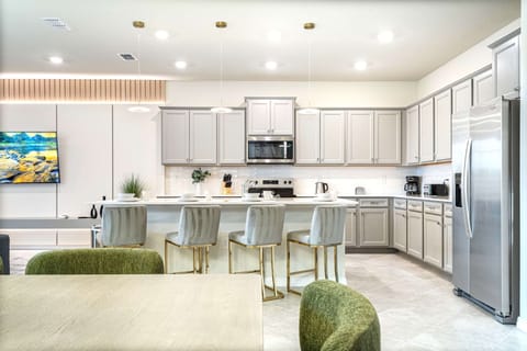 Gourmet kitchen with sleek appliances, spacious island, and stylish seating