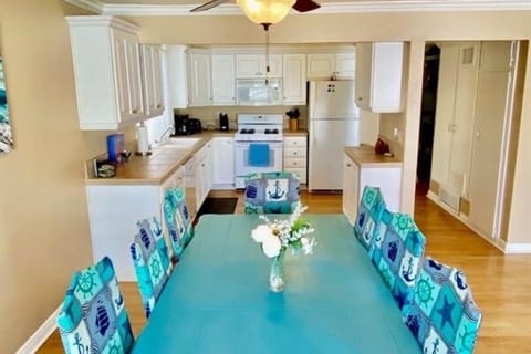 Large dining table with seating for eight adjacent to kitchen for the perfect family meal!