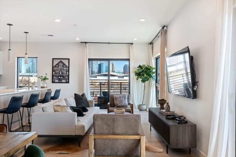 Bright living room with comfortable seating and stunning city views