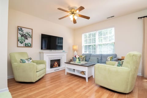First fl living room includes a smart tv, fireplace, and comfortable seating.