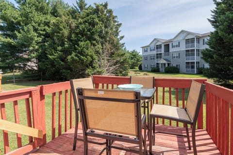 Deck includes seating for four and is nearby to the kitchen and dining table.