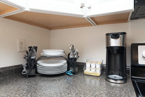 Enjoy a single cup coffeemaker, keurig cups, dishes, cutlery, pans, and glasses.