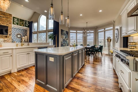 Gourmet kitchen with a massive island, custom finishes, and views that inspire every meal