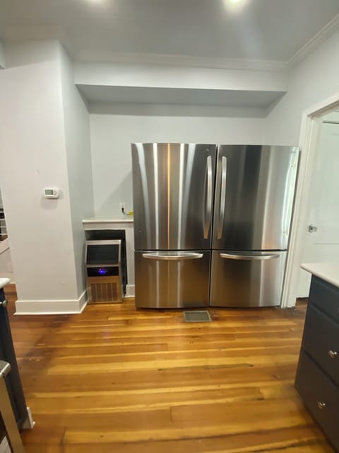 Double fridge & freezer and separate ice maker beside fridge.