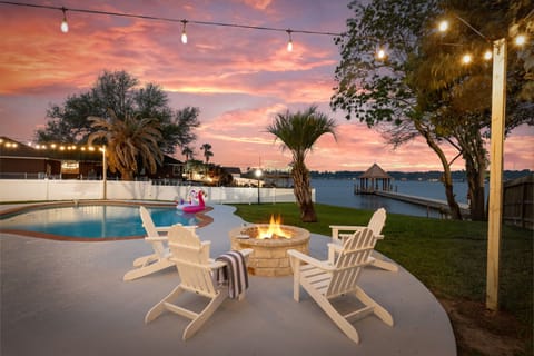 As the sun goes down, gather around the fire pit with seating for four.