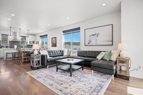 Experience the cozy living room, outfitted with plush seating, an expansive smart TV, and modern decor.