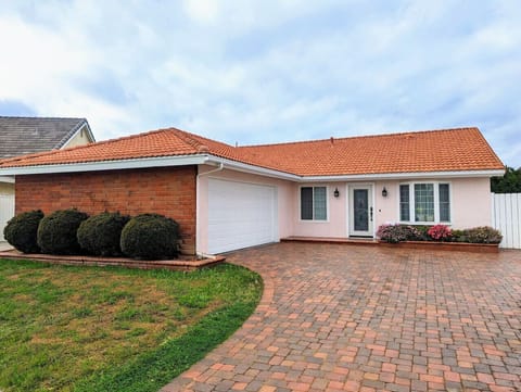 Sunshine By The Park — cheerful single-family home in Placentia with driveway parking, manicured front landscaping, and easy access to Disneyland, beaches, and Orange County attractions.
