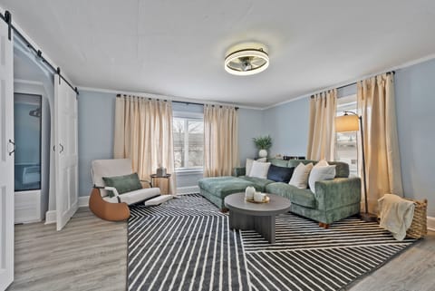 Bright, welcoming living room with cozy seating and smart TV for relaxing nights