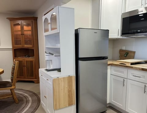 Kitchen full-size refrigerator and freezer. Also 2 burner cooktop.