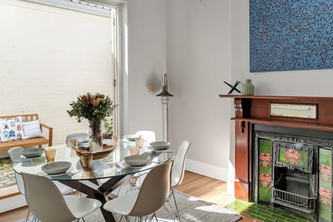Separate dining room for 6 with original ornamental fire place opening up on the outdoor patio area.  