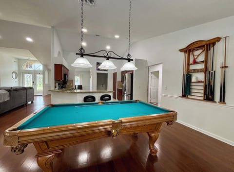 The game room has a stylish pool table and a dart board for hours of fun.