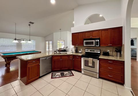 The kitchen overlooks the living room and the game room, with everything you need to prepare home cooked meals together.